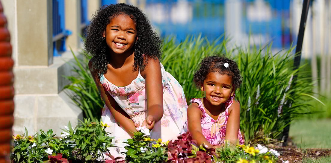Two girls gardening together